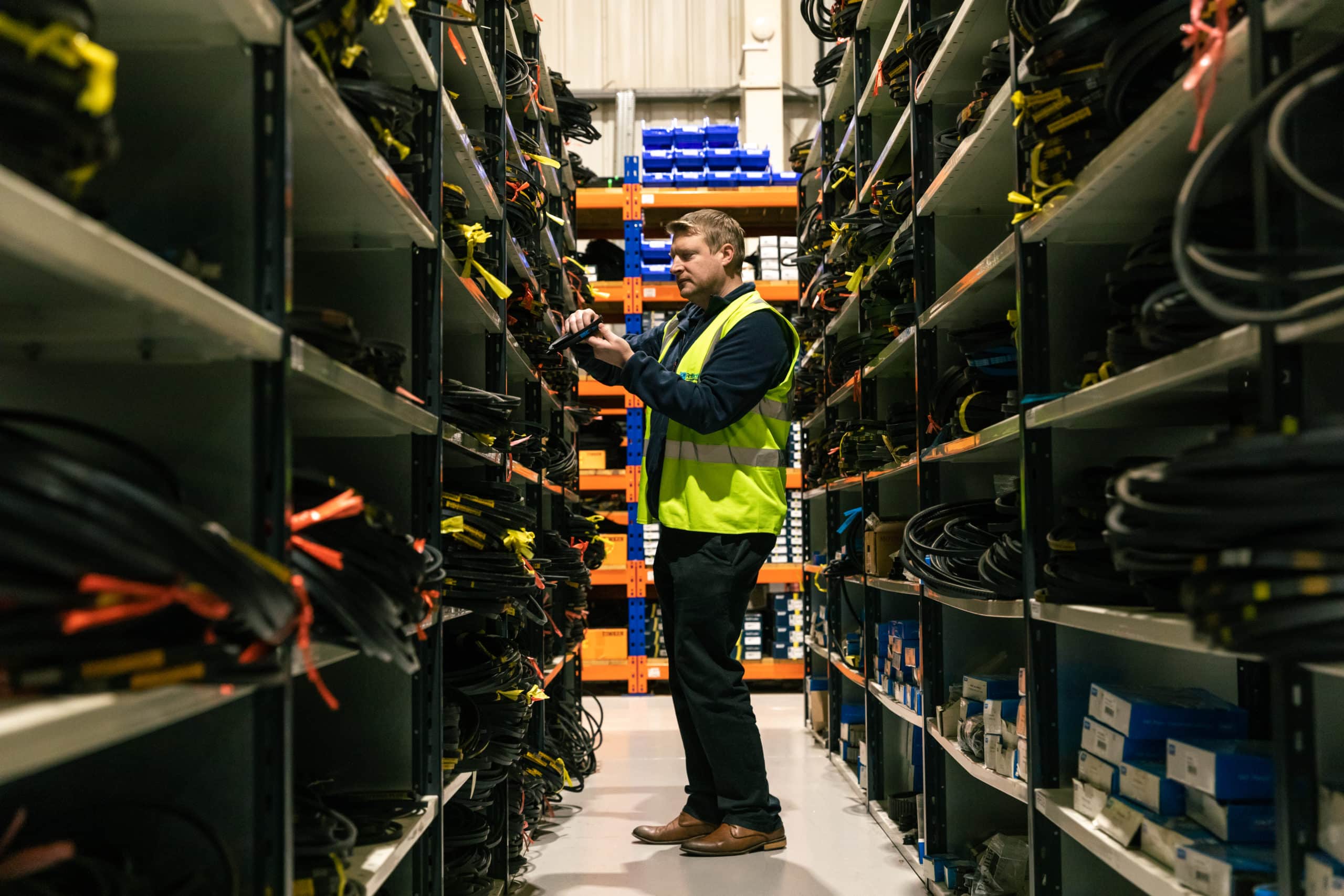 Image of warehouse worker checking stock