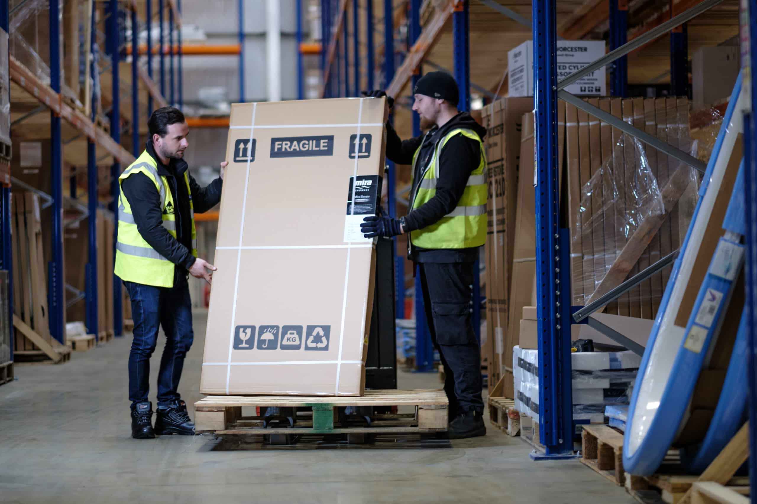 Men in warehouse movin a large box