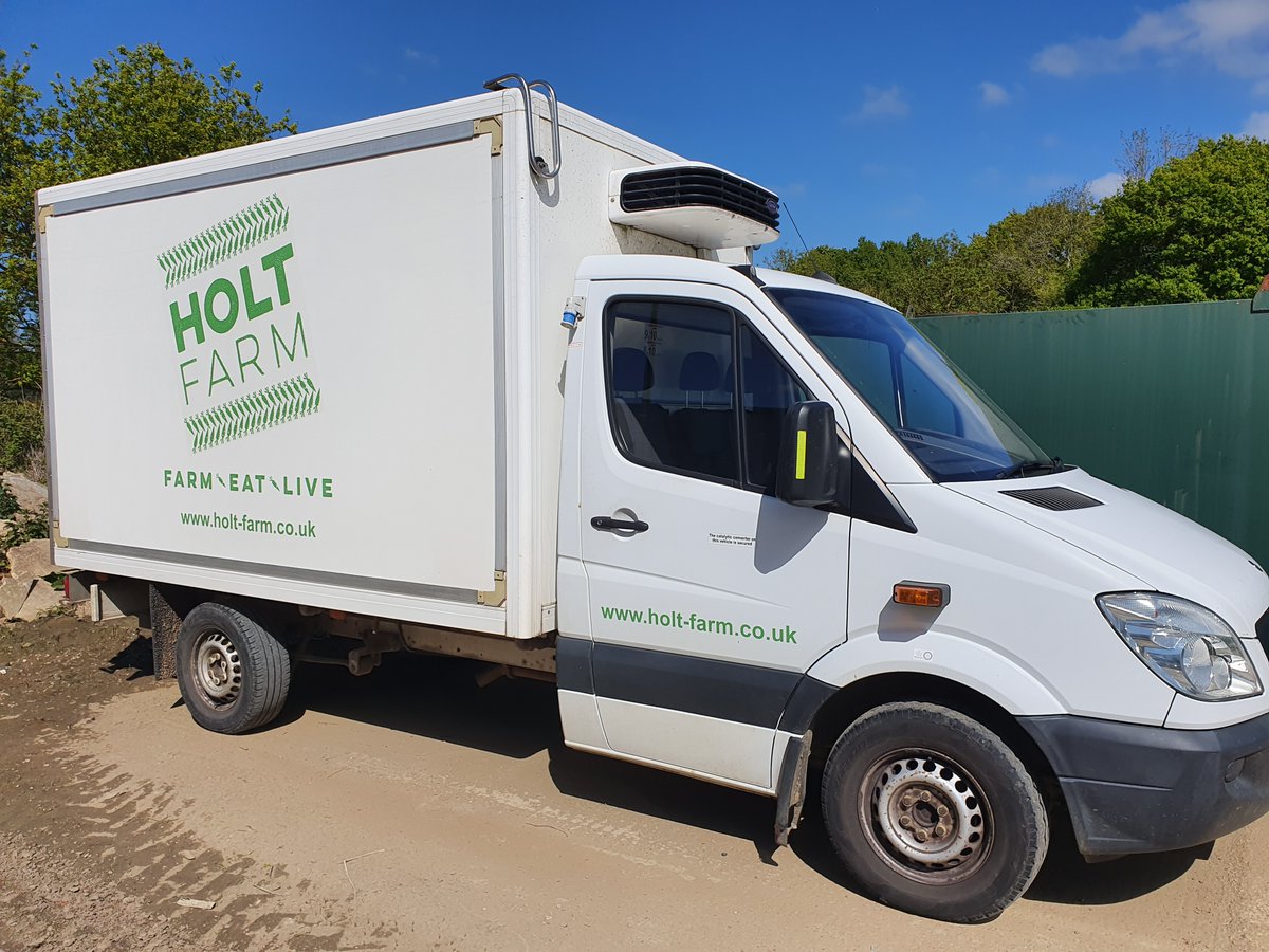 A Holt Farm van parked