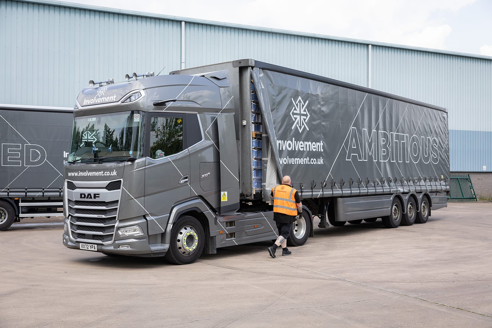 Black delivery van in Involvement branding with a driver standing outside